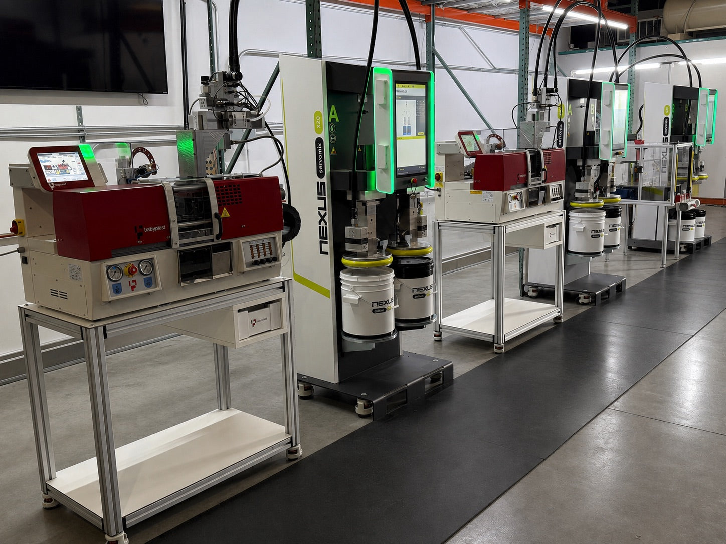 Babyplast and NEXUS injection molding cells lined up on the floor of ALBA's facility